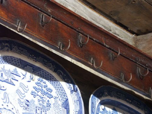 fig 1. An 18th-century Welsh oak potboard dresser featuring a multi-tiered plate rack above three drawers and an open lower potboard shelf.