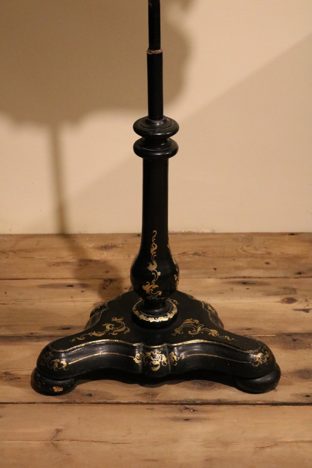 A pair of black turned ebonised pole screens featuring shaped lacquered papier-mache panels hand-painted with landscape scenes above gilded tripod bases. View VII