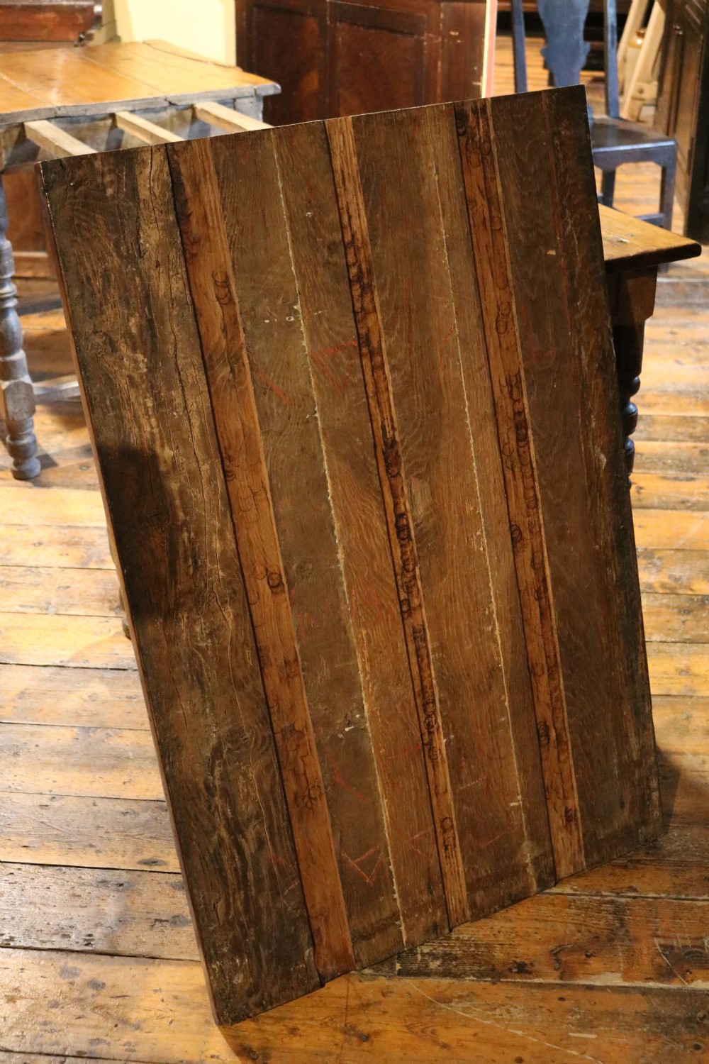A long Basque chestnut extending dining table with a plank top, turned legs, and perimeter stretchers. View X