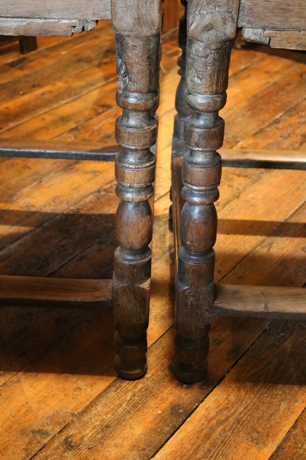 A long Basque chestnut extending dining table with a plank top, turned legs, and perimeter stretchers. View XVII