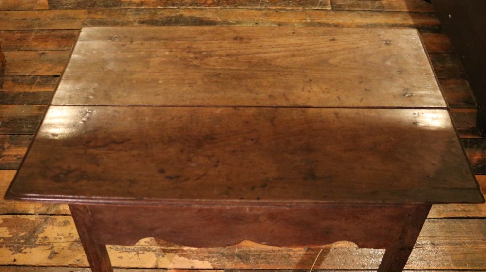 An 18th-century Welsh oak lowboy side table featuring three inlaid drawers, a scalloped lower apron, and four square legs. View VI