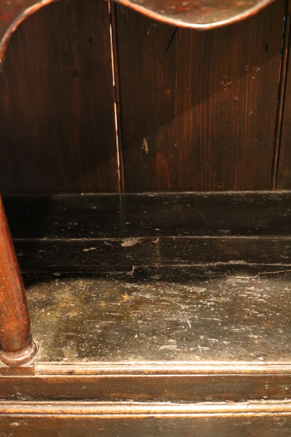 An 18th-century dark oak Welsh dresser featuring an upper plate rack, three brass-handled drawers over a scalloped apron, and a lower potboard shelf. View XV
