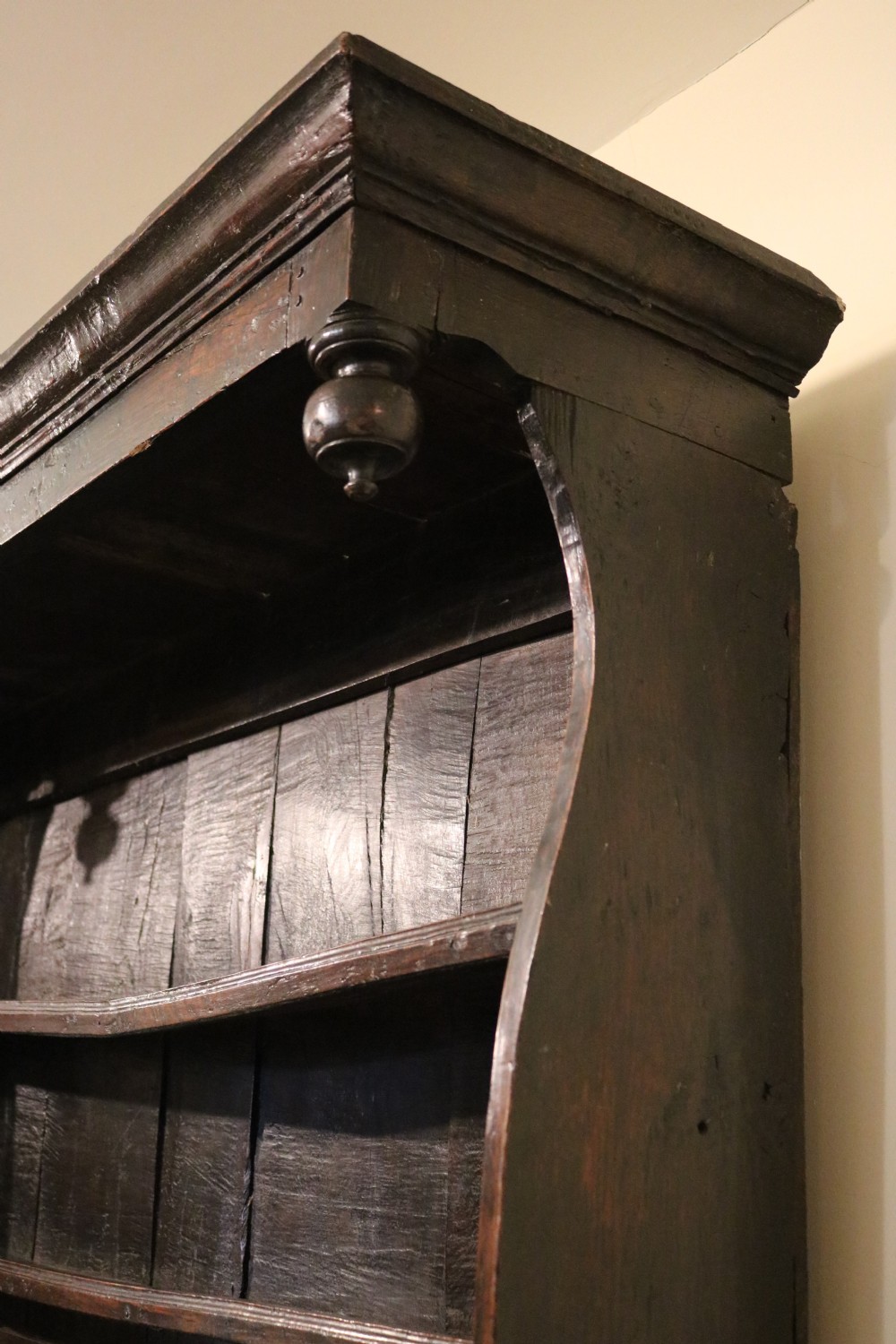 A dark oak Welsh cupboard dresser with a three-tiered upper display rack and a lower base containing two fielded panel doors. View XI