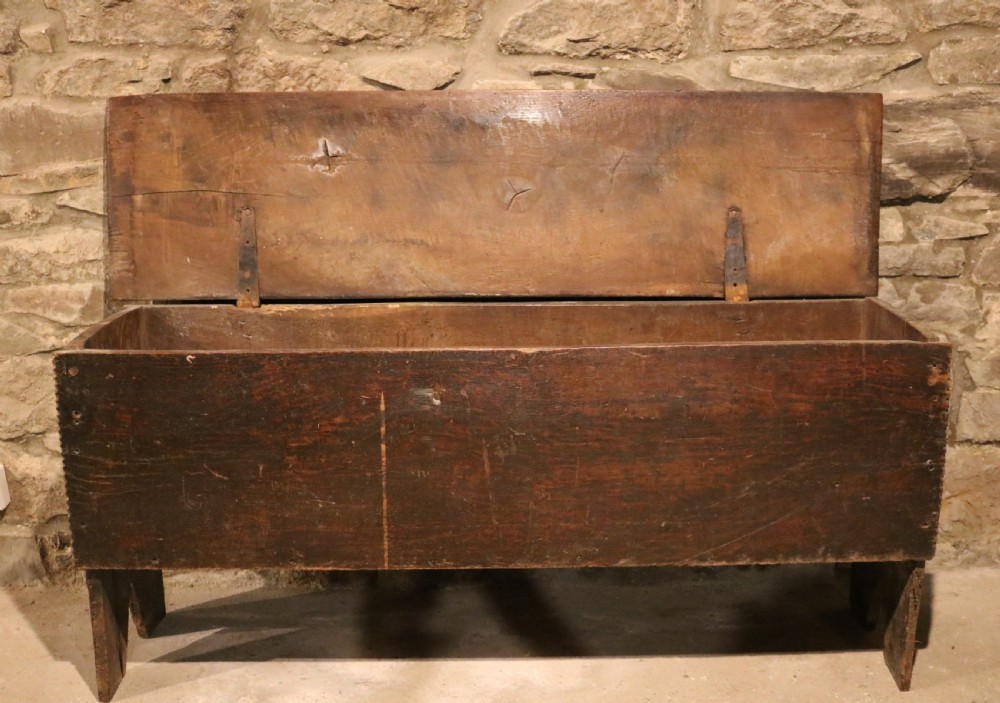 A dark brown 16th-century six-plank oak coffer featuring a rectangular top and V-cut end legs. View III