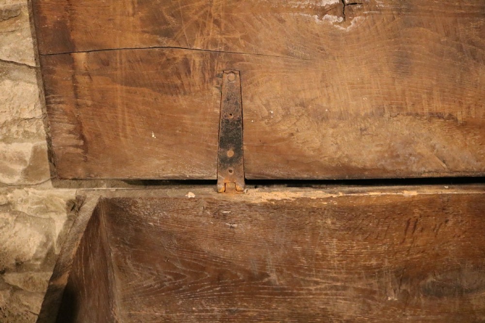 A dark brown 16th-century six-plank oak coffer featuring a rectangular top and V-cut end legs. View VIII