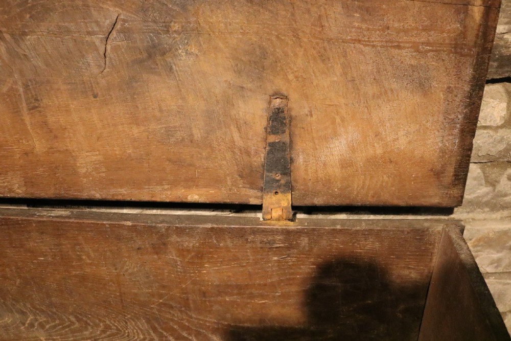 A dark brown 16th-century six-plank oak coffer featuring a rectangular top and V-cut end legs. View IX