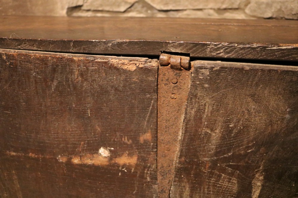 A dark brown 16th-century six-plank oak coffer featuring a rectangular top and V-cut end legs. View XIV