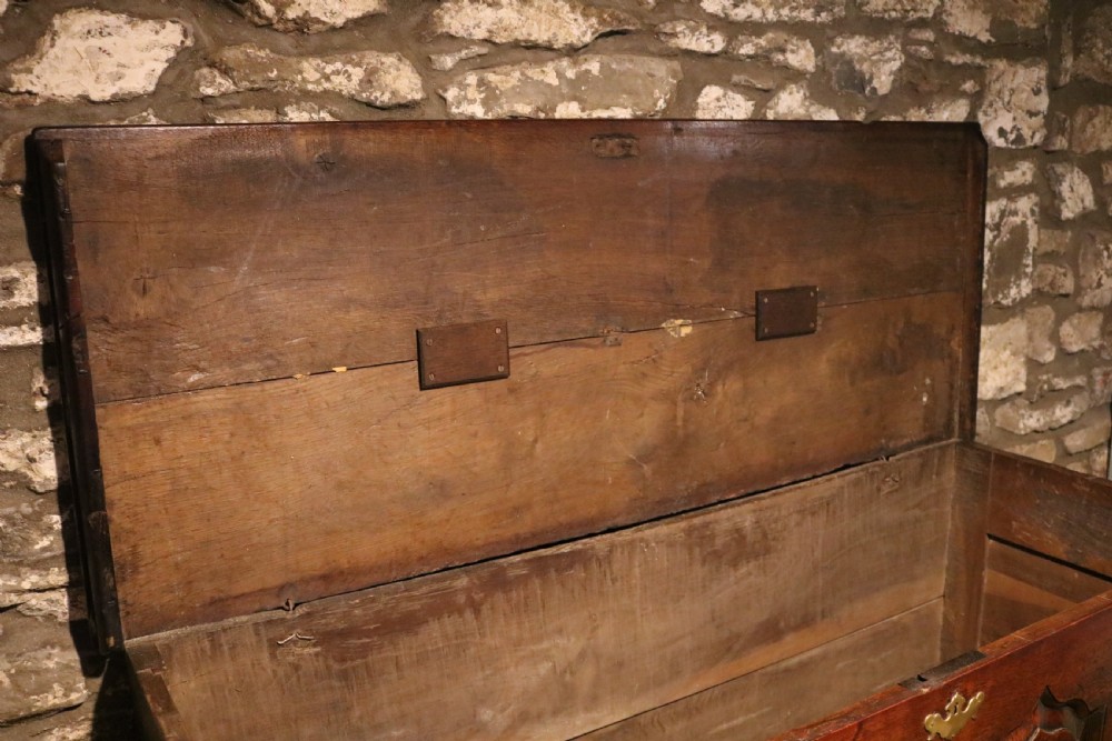 An 18th-century dark oak Welsh coffer featuring four arched inlaid panels above two drawers with brass handles. View XIII