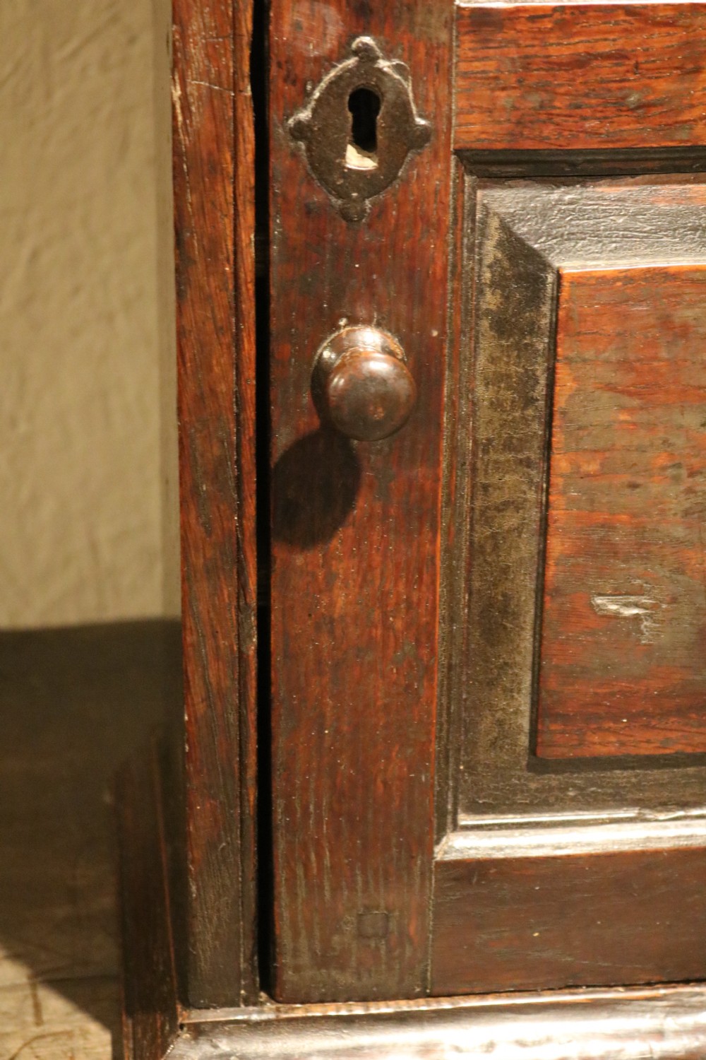 An 18th-century Welsh dark oak spice cupboard with double arched fielded panel door detailing and a diamond inlay. View VI