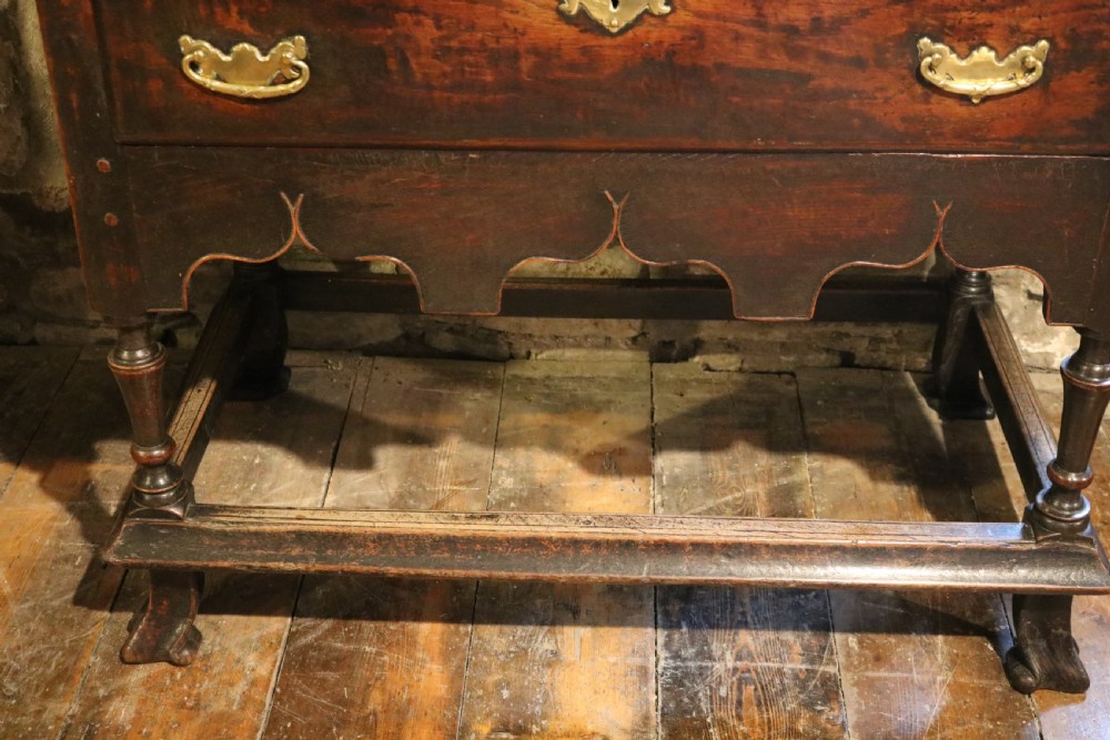 An 18th-century Welsh dark oak side table with a single drawer, brass handles, a scalloped apron, turned legs, and stretchers. View VIII