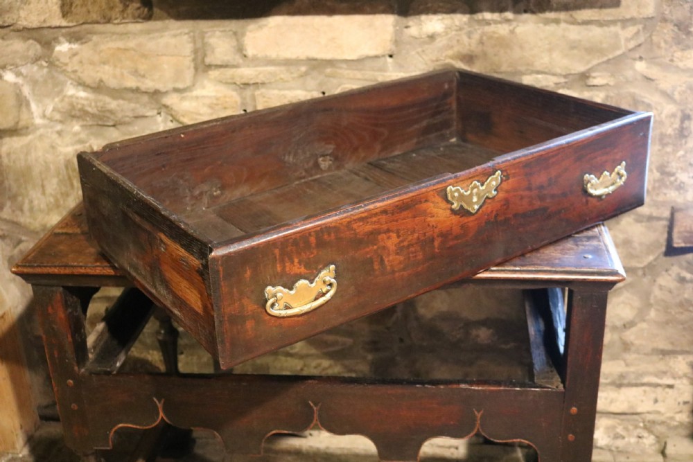 An 18th-century Welsh dark oak side table with a single drawer, brass handles, a scalloped apron, turned legs, and stretchers. View IX