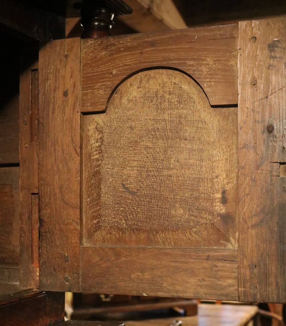 An eighteenth-century Welsh oak deuddarn two-part cupboard featuring a moulded cornice, three upper panelled doors with ogee arches, three mid drawers, and a lower cabinet with field panelled doors. View IX
