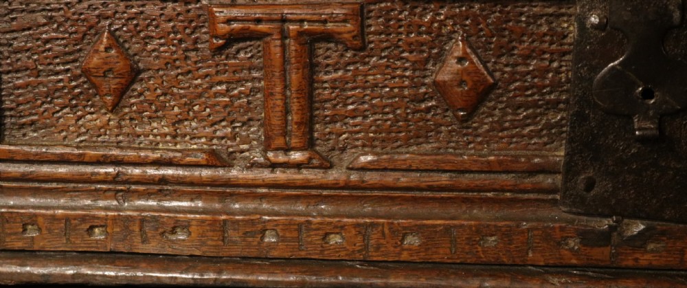 A dark oak sloped desk box featuring brass stud detailing with the year 1732, carved letters T M, and an iron lock plate. View VII