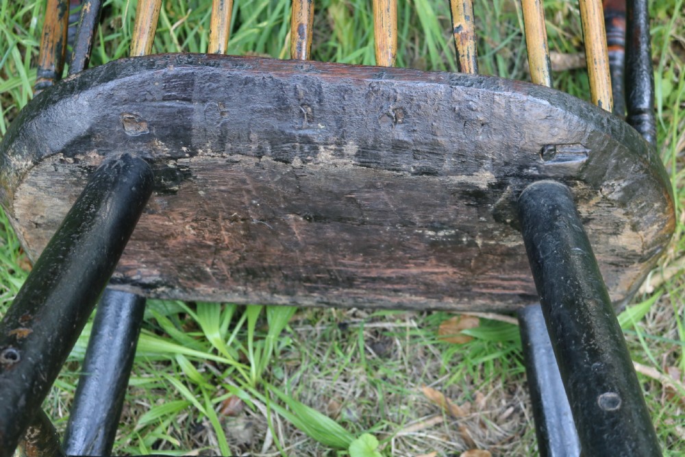 An eighteenth-century Welsh stick chair crafted from dark patinated wood featuring a comb back, curved armrests, and splayed turned legs. View VII