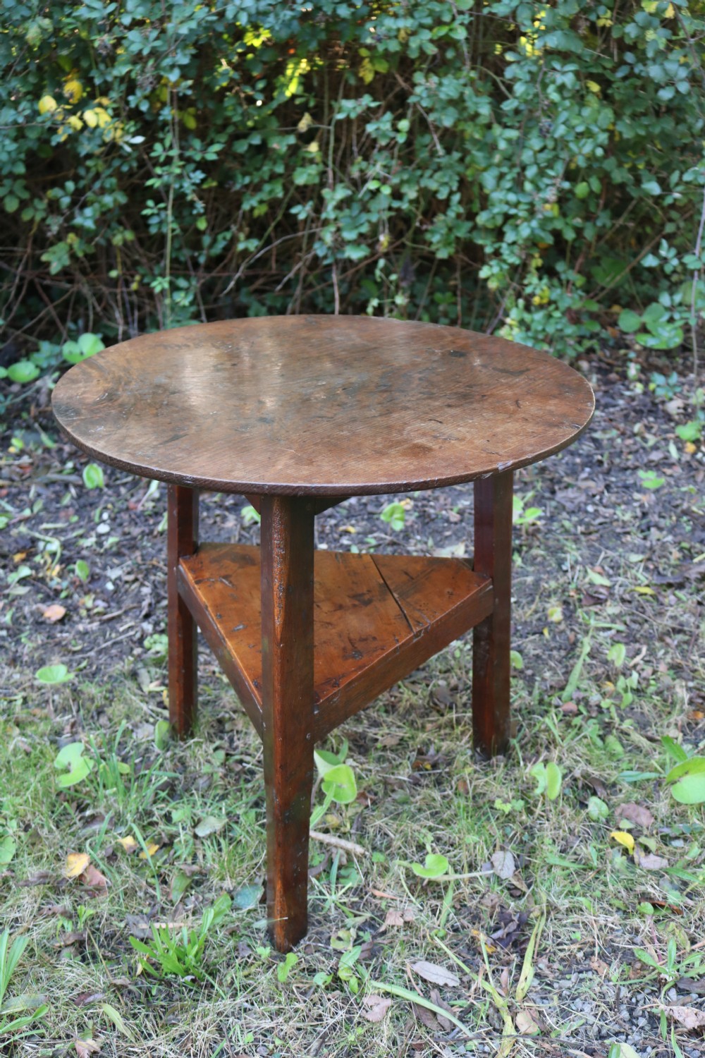 A Georgian three-legged oak cricket table featuring a circular top and a lower triangular stretcher shelf. View II