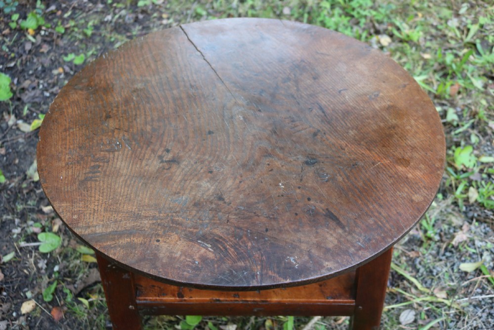 A Georgian three-legged oak cricket table featuring a circular top and a lower triangular stretcher shelf. View IV