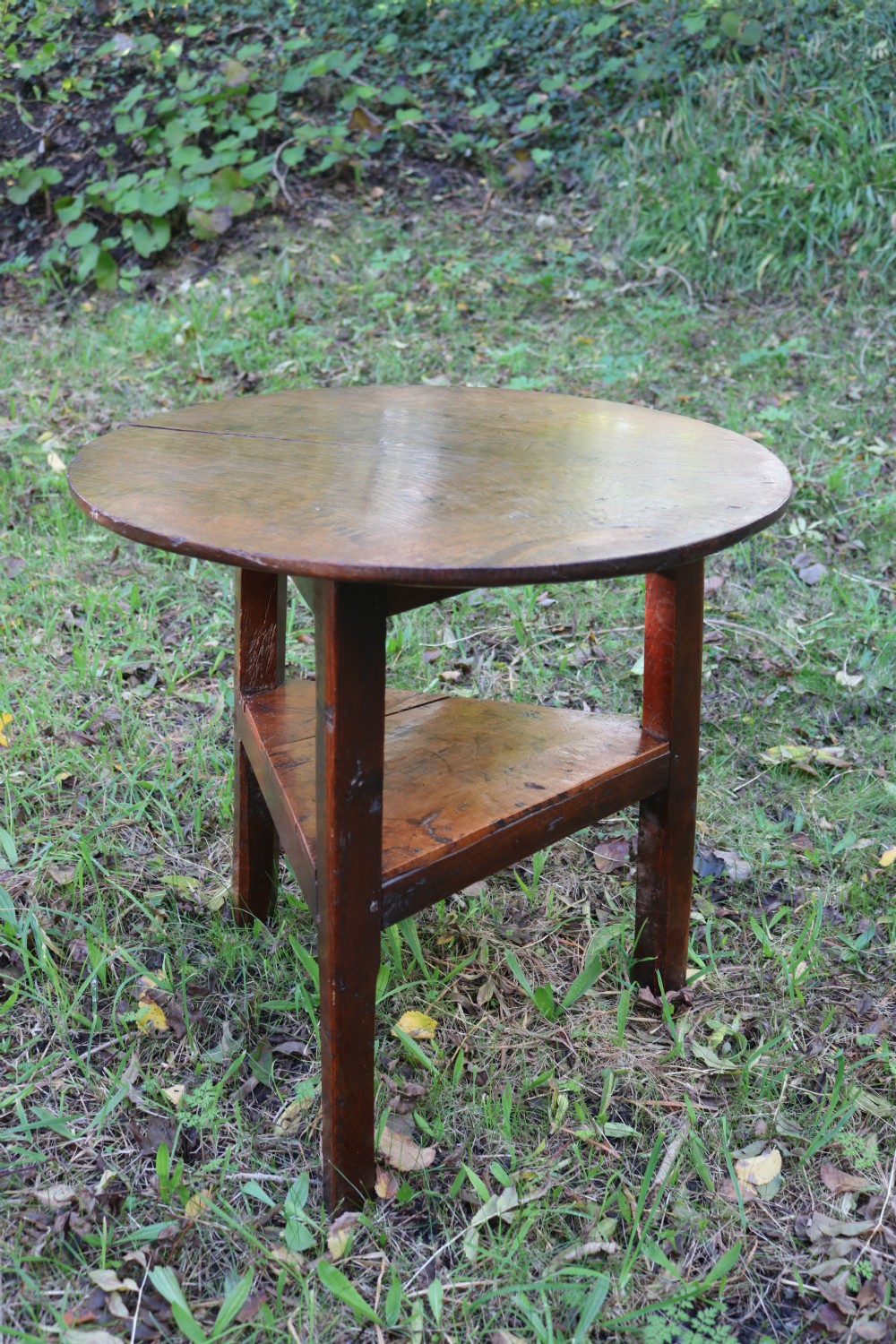 A Georgian three-legged oak cricket table featuring a circular top and a lower triangular stretcher shelf. View IX
