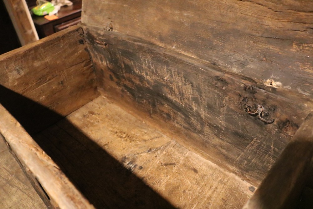 An antique dark brown chestnut wood deed box featuring carved Gothic arch panels and a hand-forged iron lock plate on the front. View XII