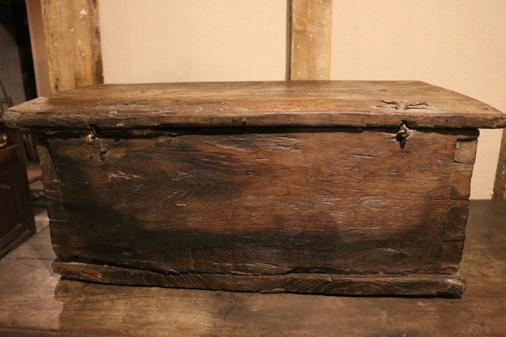 An antique dark brown chestnut wood deed box featuring carved Gothic arch panels and a hand-forged iron lock plate on the front. View XVIII