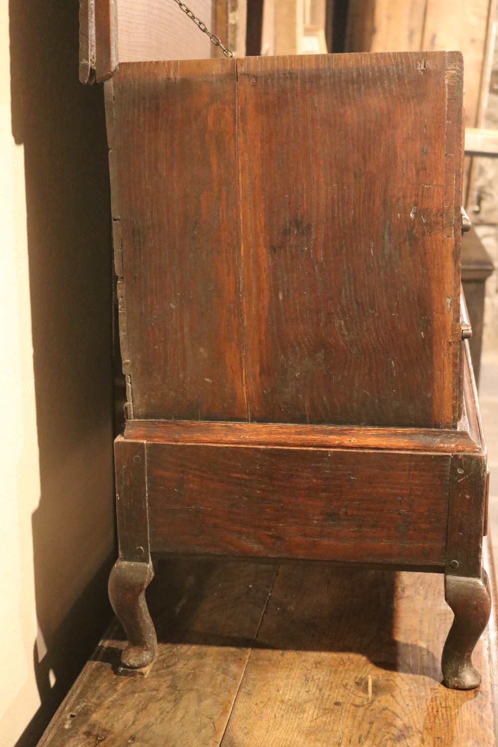 An eighteenth-century dark oak miniature tallboy chest featuring geometric panelled drawer fronts, brass tear-drop handles, and cabriole legs. View VIII