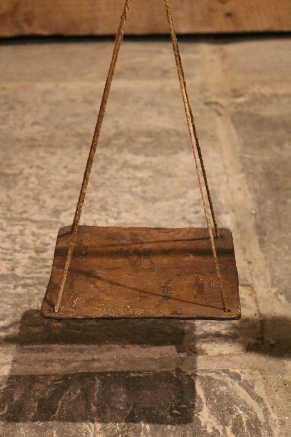 A Georgian turned oak balance scale featuring two wooden square pans suspended by cords from a wooden crossbar. View V