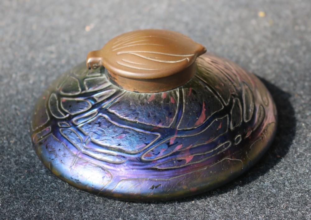 A low domed Art Nouveau iridescent blue glass inkwell with raised veined patterns and a hinged brass lid. View III