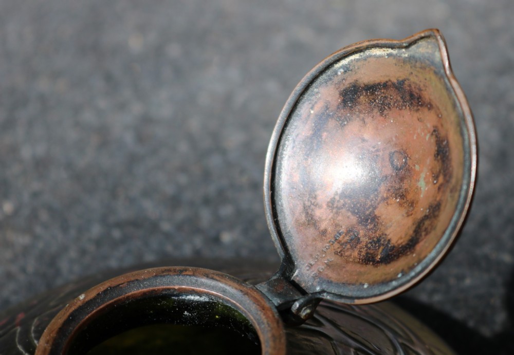 A low domed Art Nouveau iridescent blue glass inkwell with raised veined patterns and a hinged brass lid. View VIII