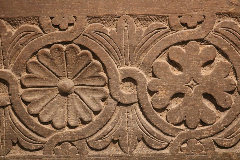 A 16th-century Tudor carved oak coffer featuring a carved rosette frieze, central wrought iron lockplate, and slab end supports. View III