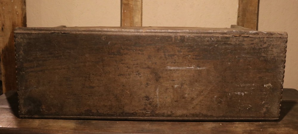 A 16th-century Tudor carved oak coffer featuring a carved rosette frieze, central wrought iron lockplate, and slab end supports. View VII