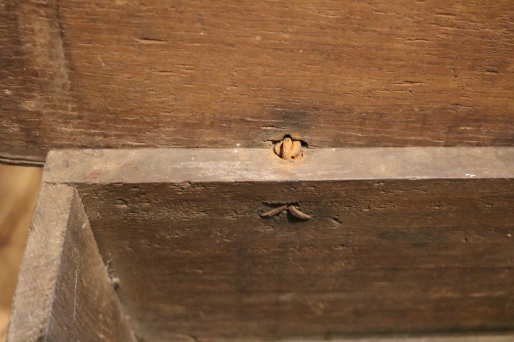 A 16th-century Tudor carved oak coffer featuring a carved rosette frieze, central wrought iron lockplate, and slab end supports. View VIII