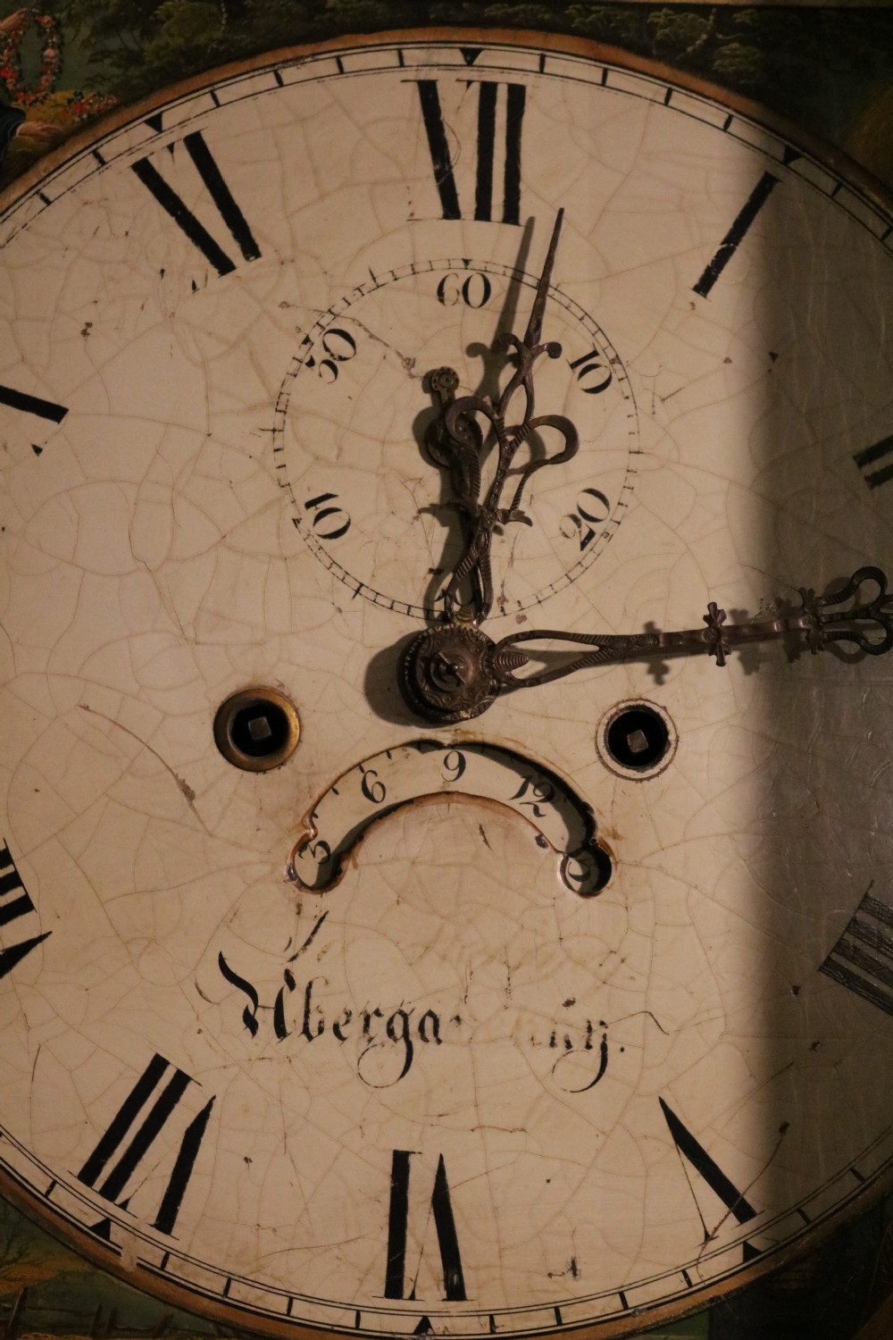 A tall 19th-century Welsh mahogany longcase clock featuring a swan-neck pediment hood, painted arch dial with Roman numerals, and flame mahogany trunk door. View X