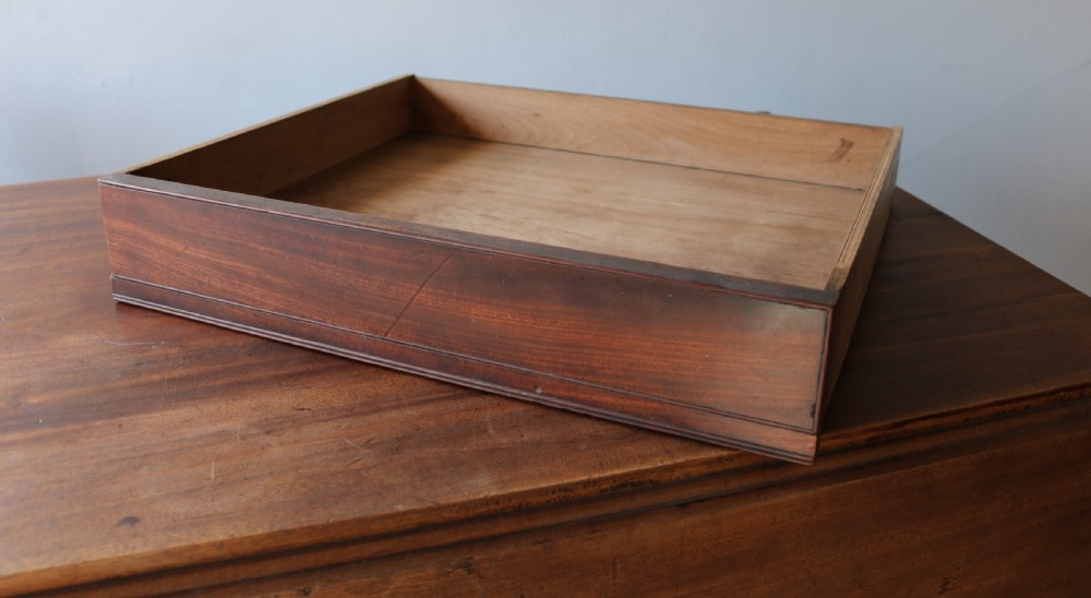 A Regency mahogany dining table featuring a rectangular drop-leaf top supported by a central reeded pedestal and four splayed legs with brass toe castors. View IX