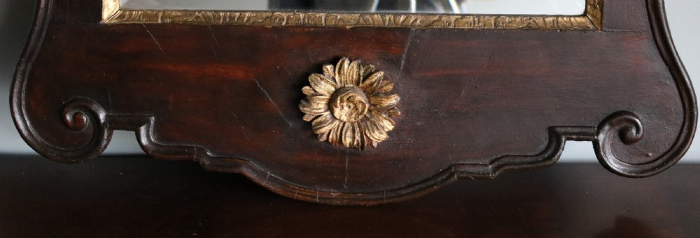 A dark mahogany Georgian Chippendale wall mirror featuring a carved gilt shell cresting, inner gilt moulding slip, and a bottom gilt patera rosette. View IV