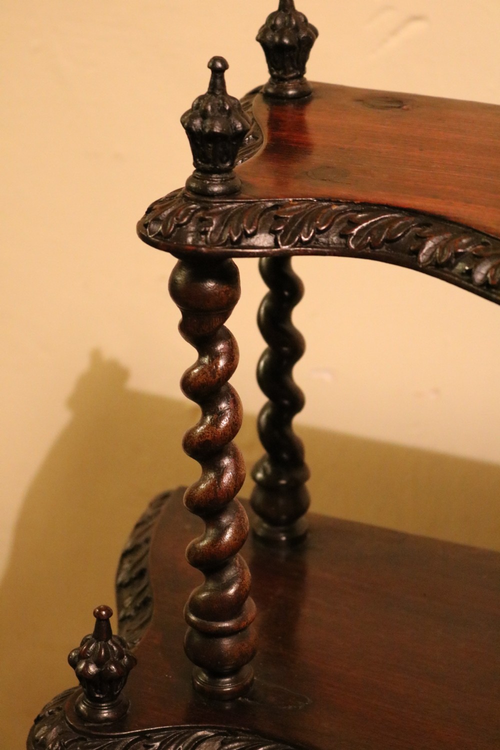A five-tiered Regency rosewood whatnot with barley twist support columns, carved serpentine edges, and top finials. View VII