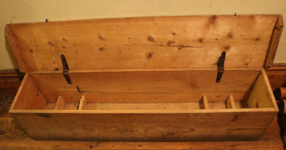 An open pine box containing an antique croquet set with wooden mallets, painted winning posts, and white metal hoops. View IV