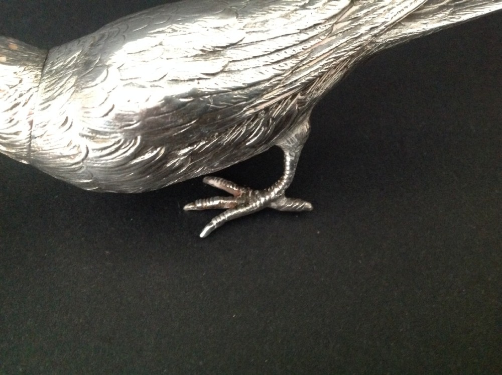 A cast silver pepper pot fashioned in the detailed form of a standing bird with pierced holes on its head. View II