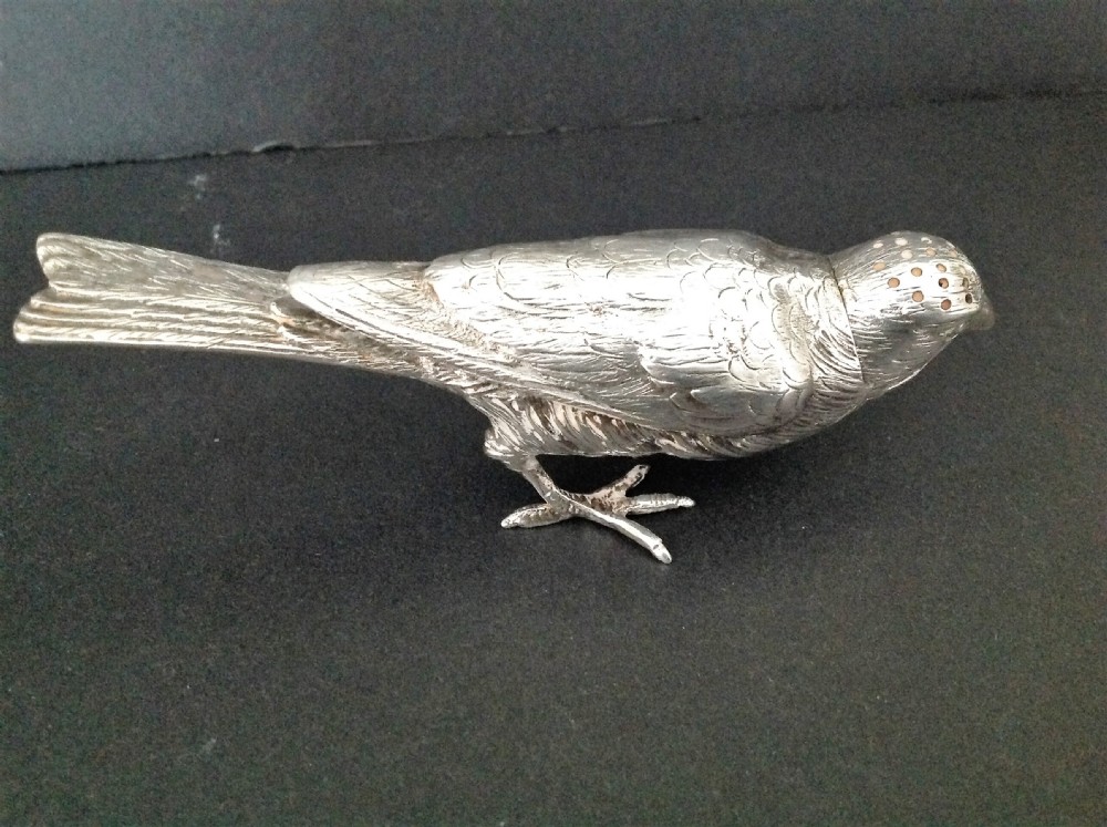 A cast silver pepper pot fashioned in the detailed form of a standing bird with pierced holes on its head. View III