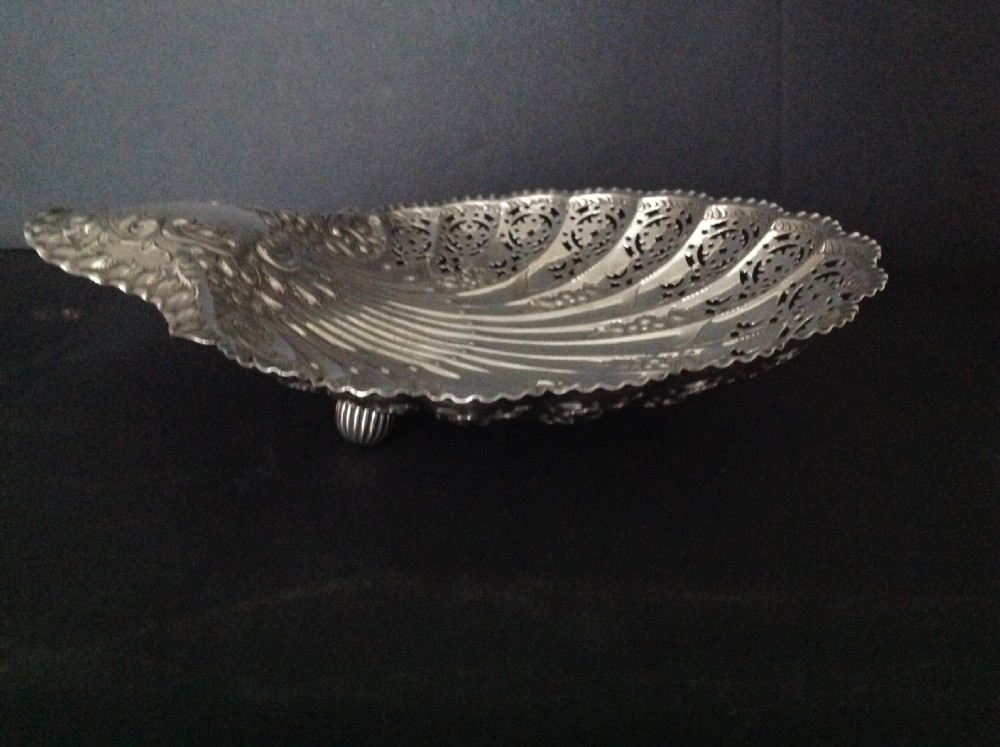 A late Victorian silver dish shaped like a scallop shell featuring detailed pierced scrollwork and fluted ridges. View III