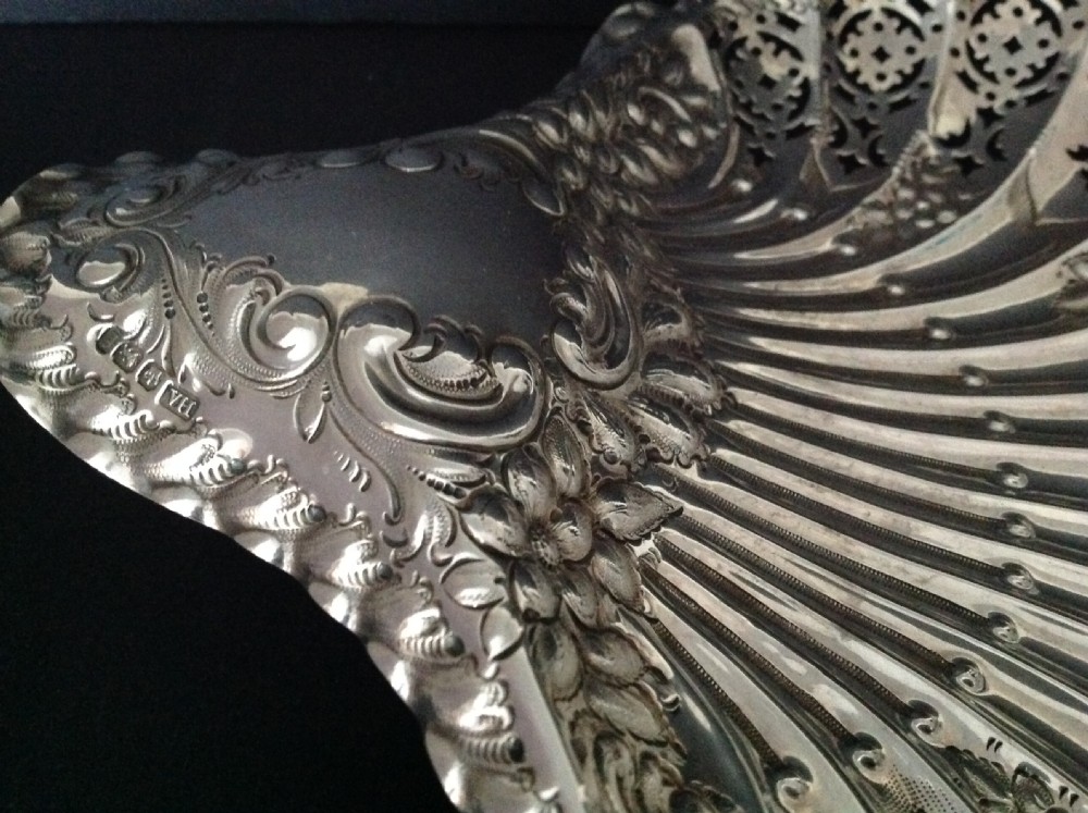 A late Victorian silver dish shaped like a scallop shell featuring detailed pierced scrollwork and fluted ridges. View IV