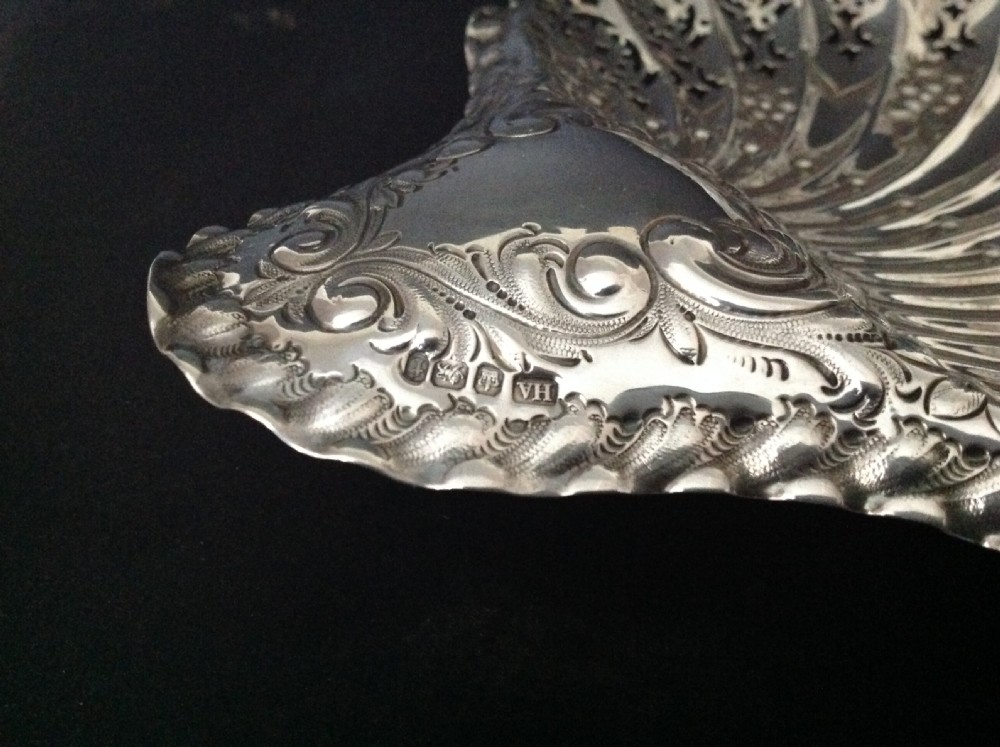 A late Victorian silver dish shaped like a scallop shell featuring detailed pierced scrollwork and fluted ridges. View VII