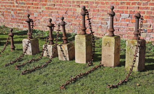 fig 1. Set of 7 cast iron bollards with stone bases