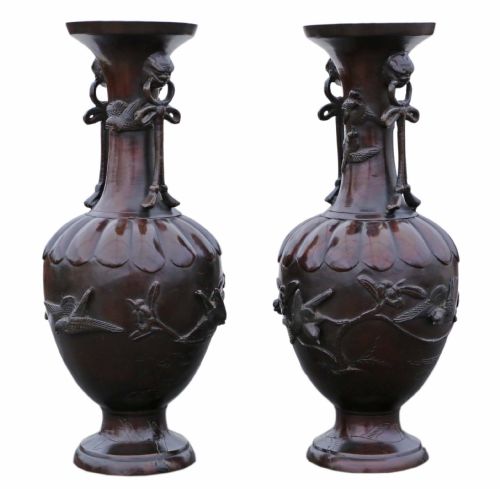 fig 1. A pair of large Japanese dark bronze presentation vases featuring high-relief bird motifs alongside stylized drop handles.