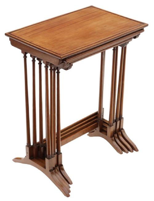fig 1. A set of four antique mahogany nesting tables with turned spindle legs, inlaid edge borders, and flared splayed feet.