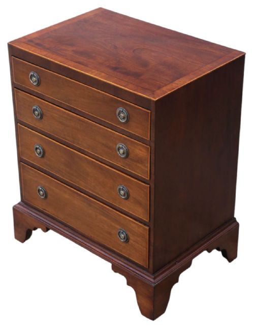fig 1. A Georgian Revival mahogany chest of drawers with four graduated drawers, brass ring handles, boxwood inlay, and bracket feet.