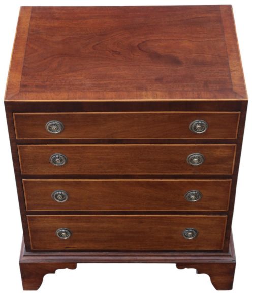 fig 2. A Georgian Revival mahogany chest of drawers with four graduated drawers, brass ring handles, boxwood inlay, and bracket feet.