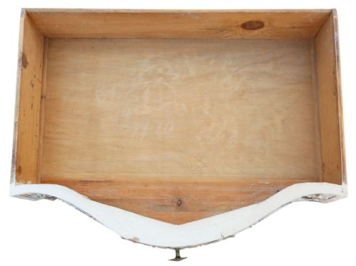 fig 1. A cream-painted Italian serpentine chest of drawers featuring three carved drawer fronts and distressed paint finish.