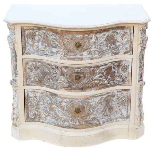 fig 2. A cream-painted Italian serpentine chest of drawers featuring three carved drawer fronts and distressed paint finish.