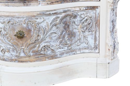 fig 3. A cream-painted Italian serpentine chest of drawers featuring three carved drawer fronts and distressed paint finish.