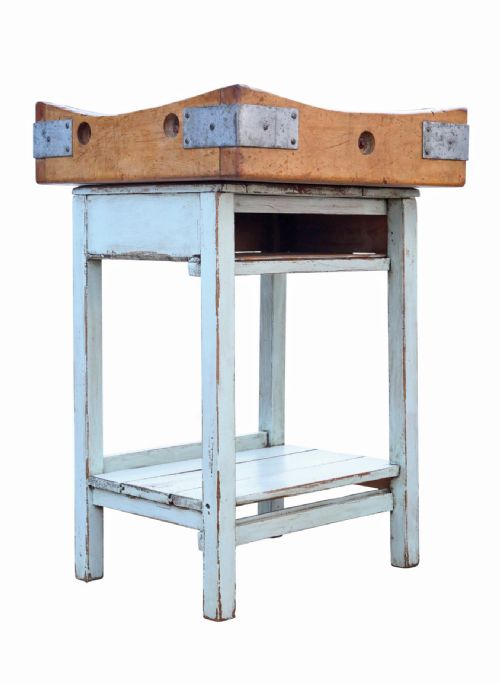 fig 1. A mid-twentieth-century wooden butchers block with a dished end-grain top, metal corner brackets, and a pale blue painted wooden stand with a lower shelf.