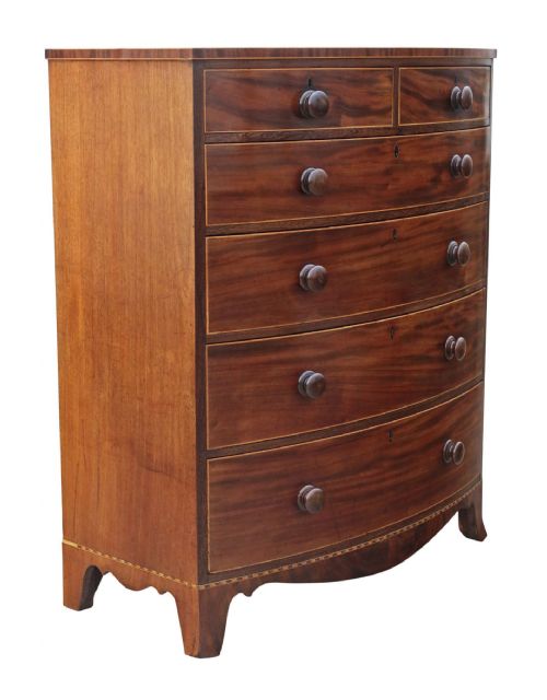fig 1. A nineteenth century mahogany bow front chest of drawers with two short over three long graduated drawers, featuring turned timber handles and delicate boxwood stringing.